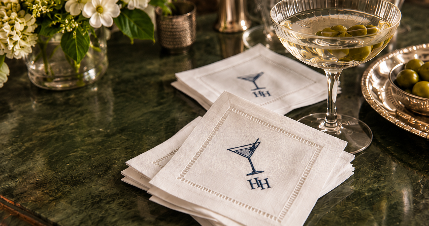Hayden Harlow embroidered linen cocktail napkins styled on a tabletop